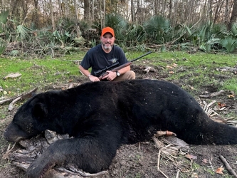 Hunter with a harvested black bear