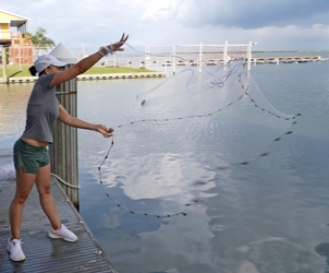 Woman throwing a cast net