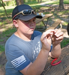 Child tying a fishing knot