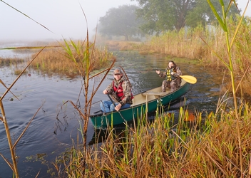 Two young adults riding together in a kayak at White Lake Conservation Area 