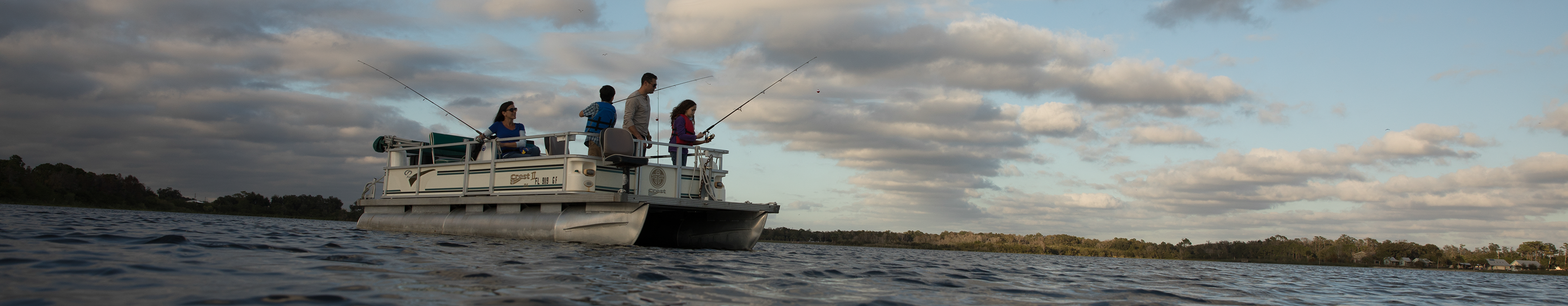 Family fishing in a pontoon boat