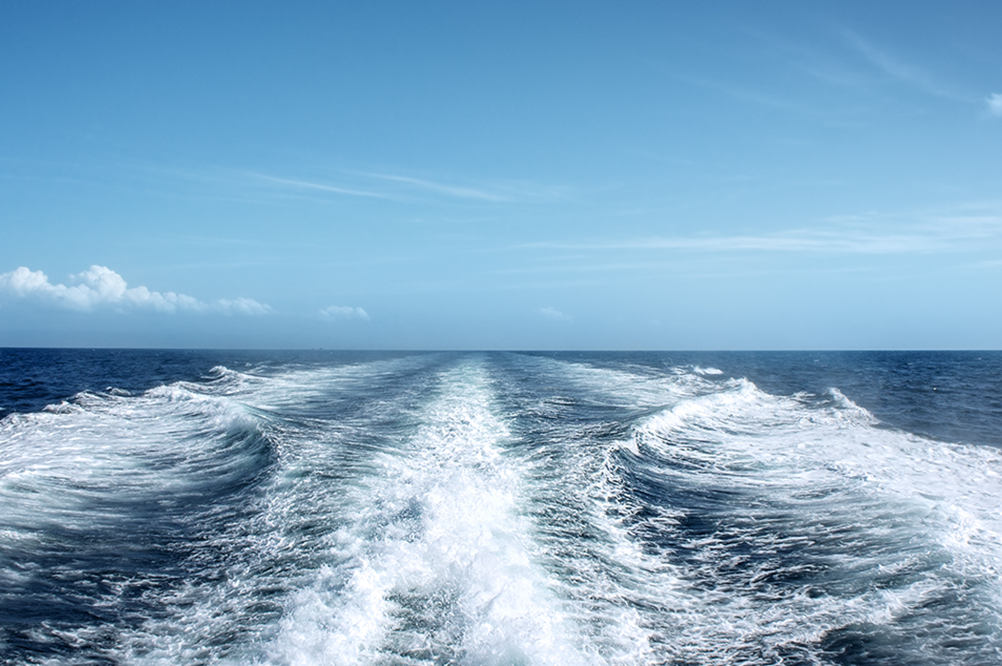 Boat wake and a blue horizon