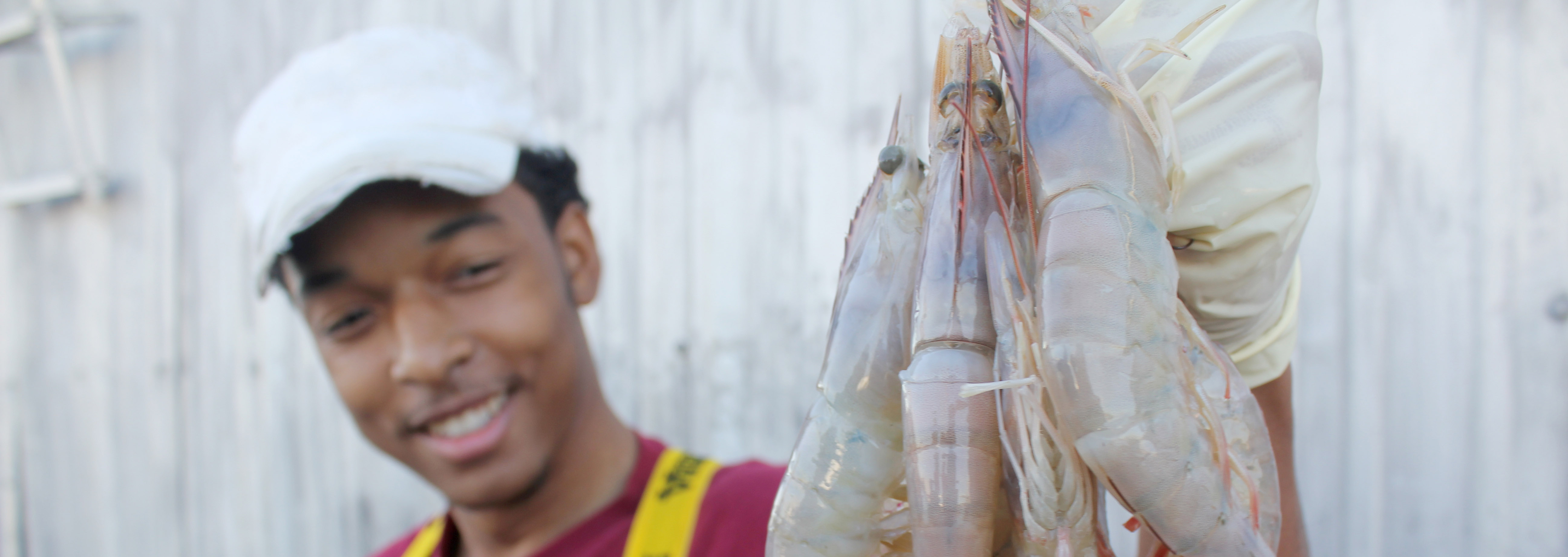 Man holding shrimp in the air