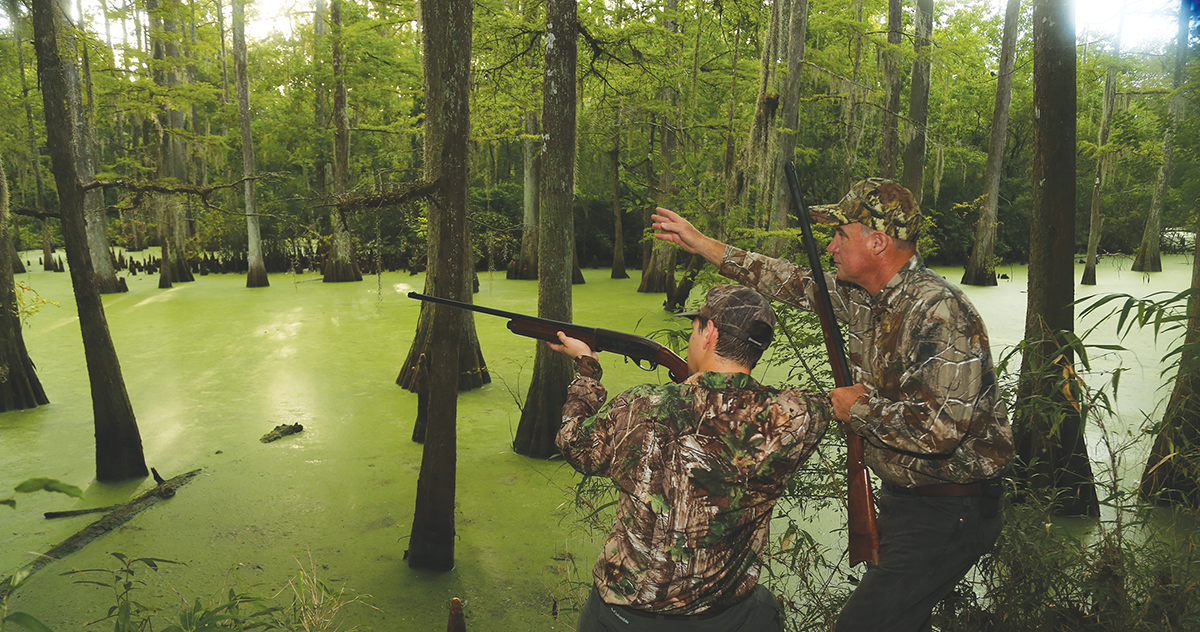 two hunters hunting flooded timber