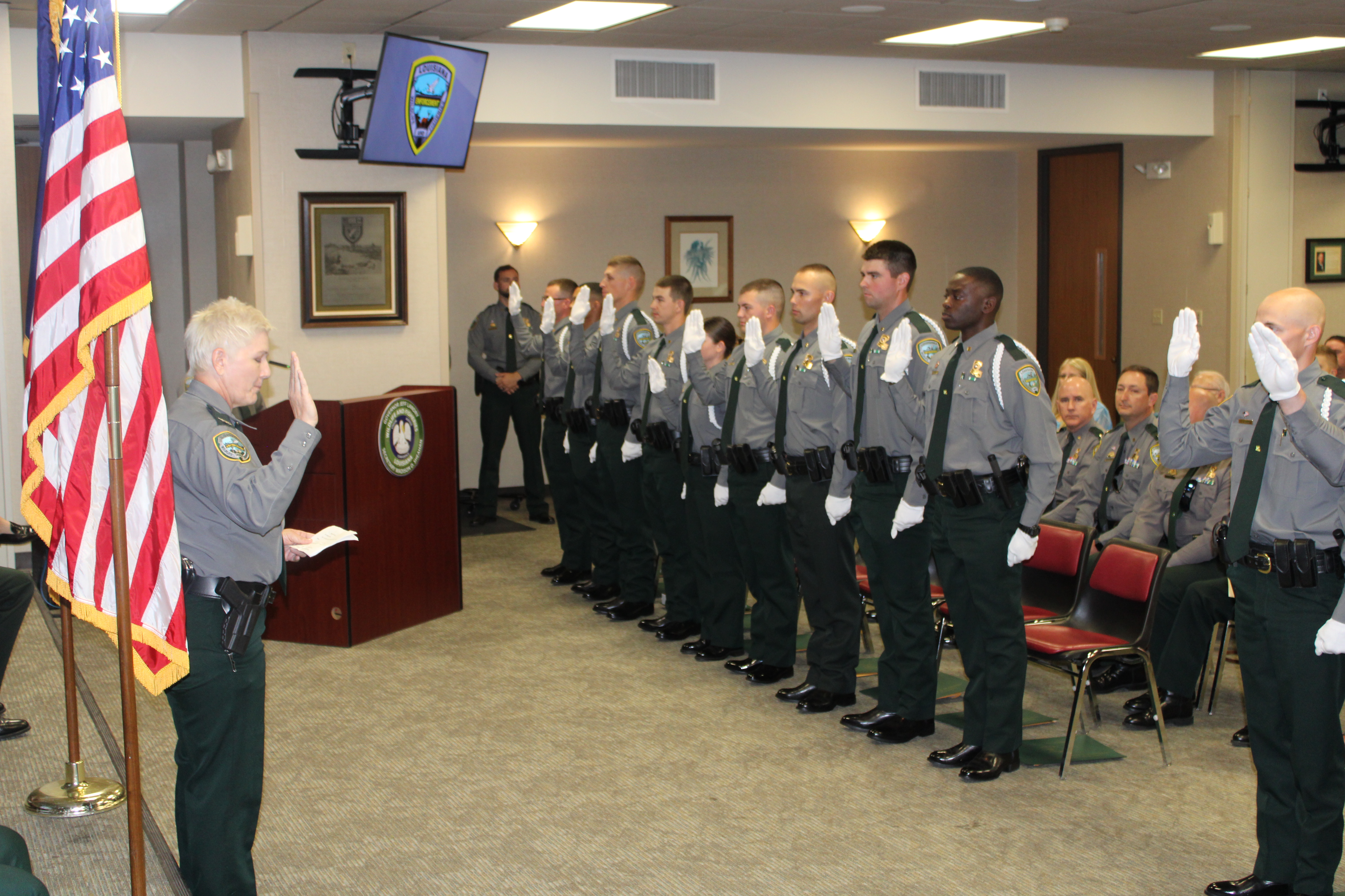 Col. Rachel Zechenelly reciting the Oath of Office to the 19 new agents.