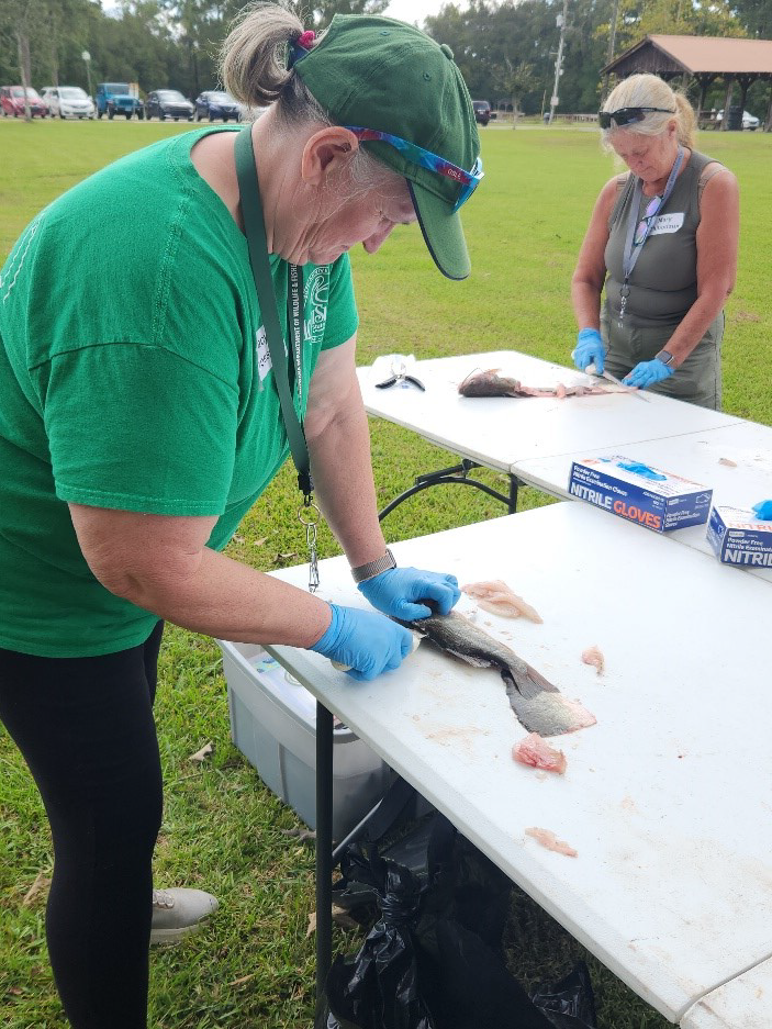 woman filleting a fish