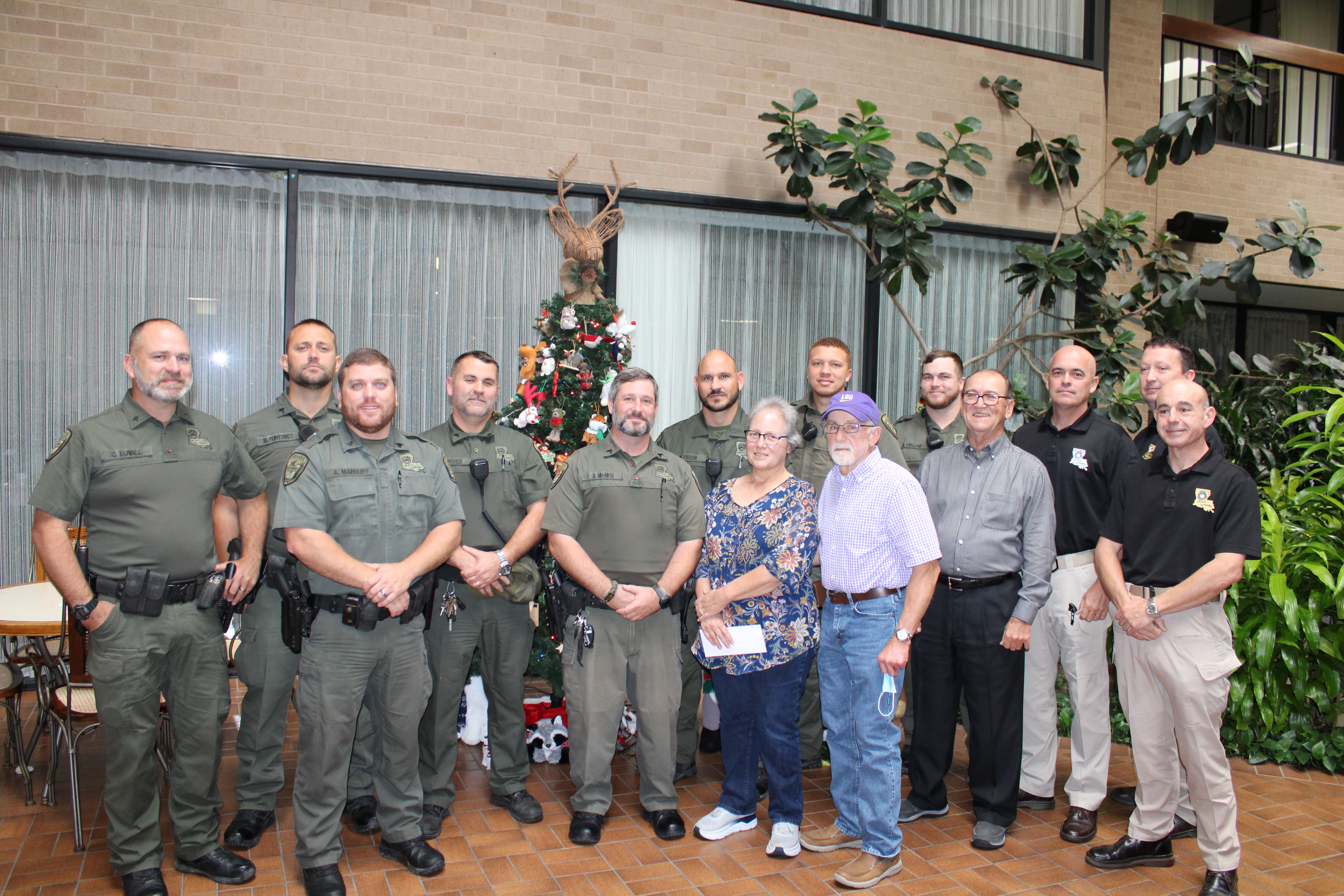 Left to right: Sgt. Channing Duvall, Corporal Brandon Fontenot, Sgt. Allan Marbury, Corporal Jason Sanchez,  Corporal Jason Marks, Senior Agent Adam Tieben, Patricial Melancon, Senior Agent Nelson Kennerson, Ronald Melancon, Agent Garrett Kirkland, Sec. Jack Montoucet, Col. Chad Hebert, Lt. Col. Travis Huvall and Major Eddie Skena.