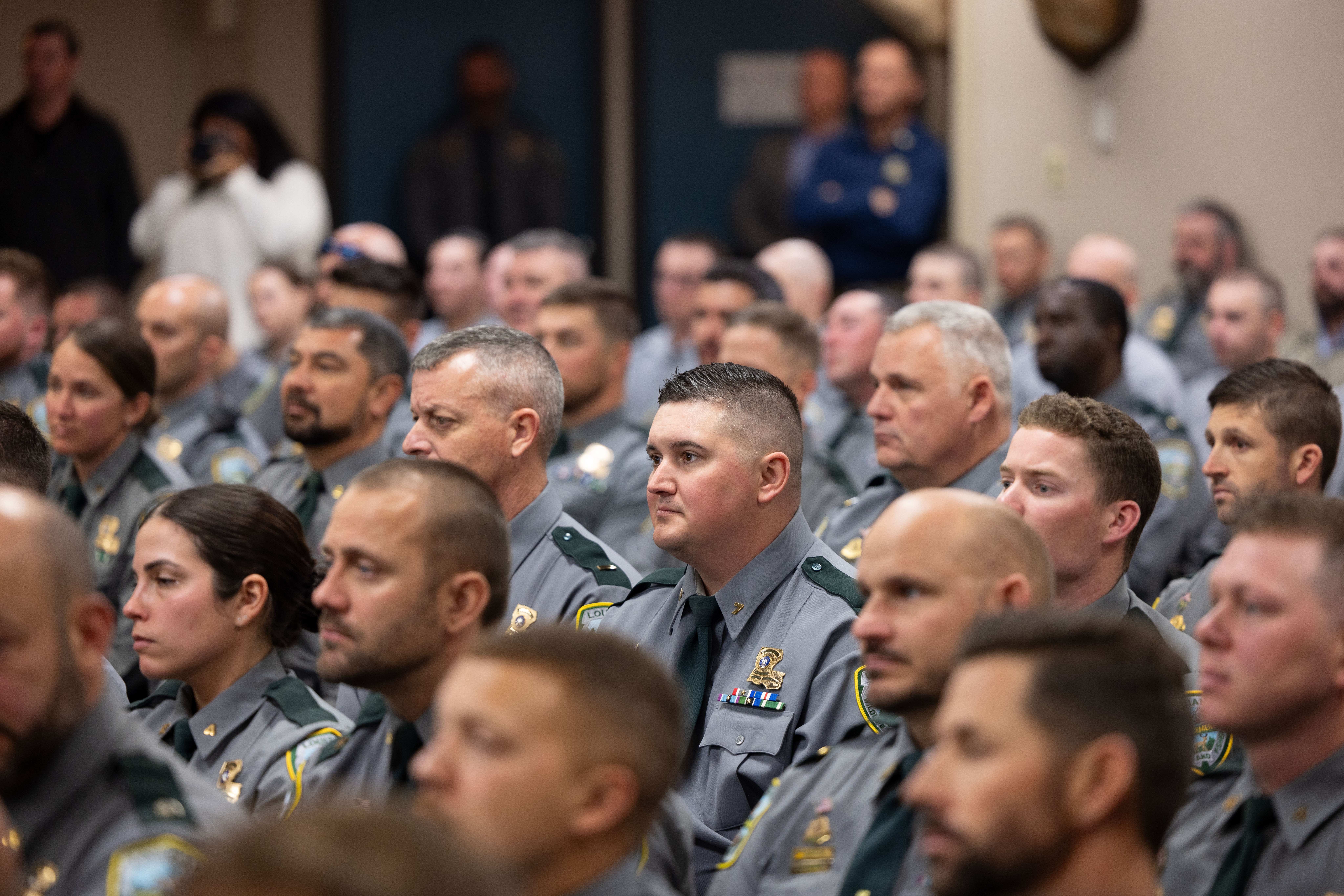Agents listen on as Gov. Landry delivers his speech.