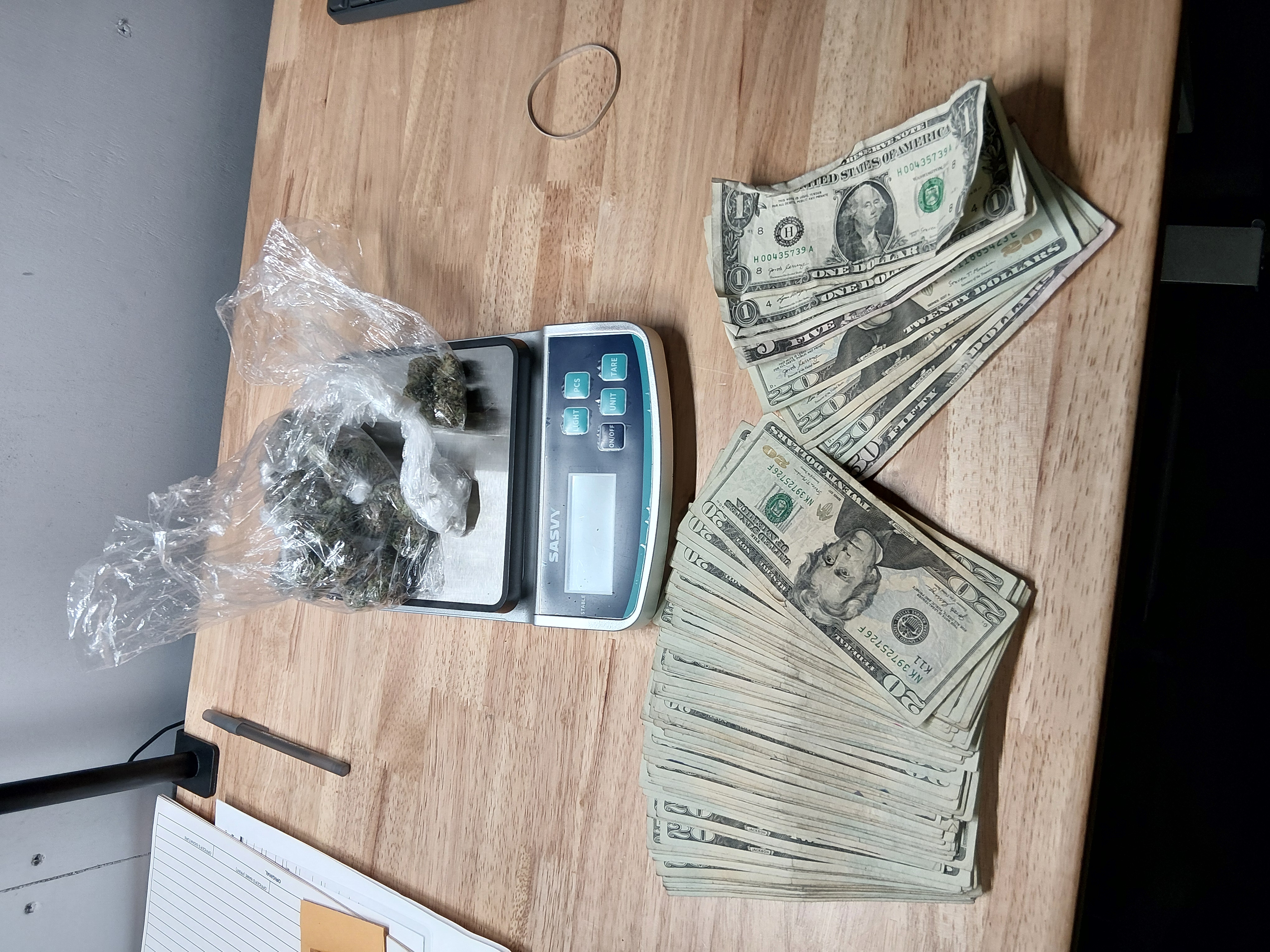 Photo of cocaine, marijuana and cash seized as evidence