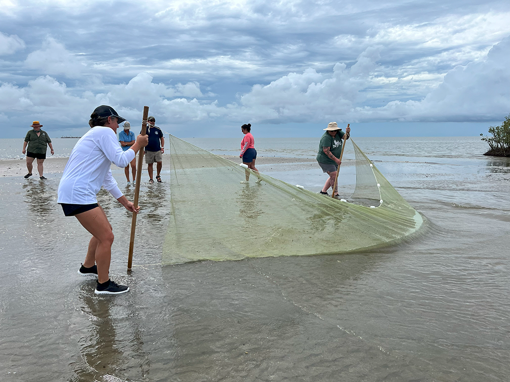 Women using a seine on the beach