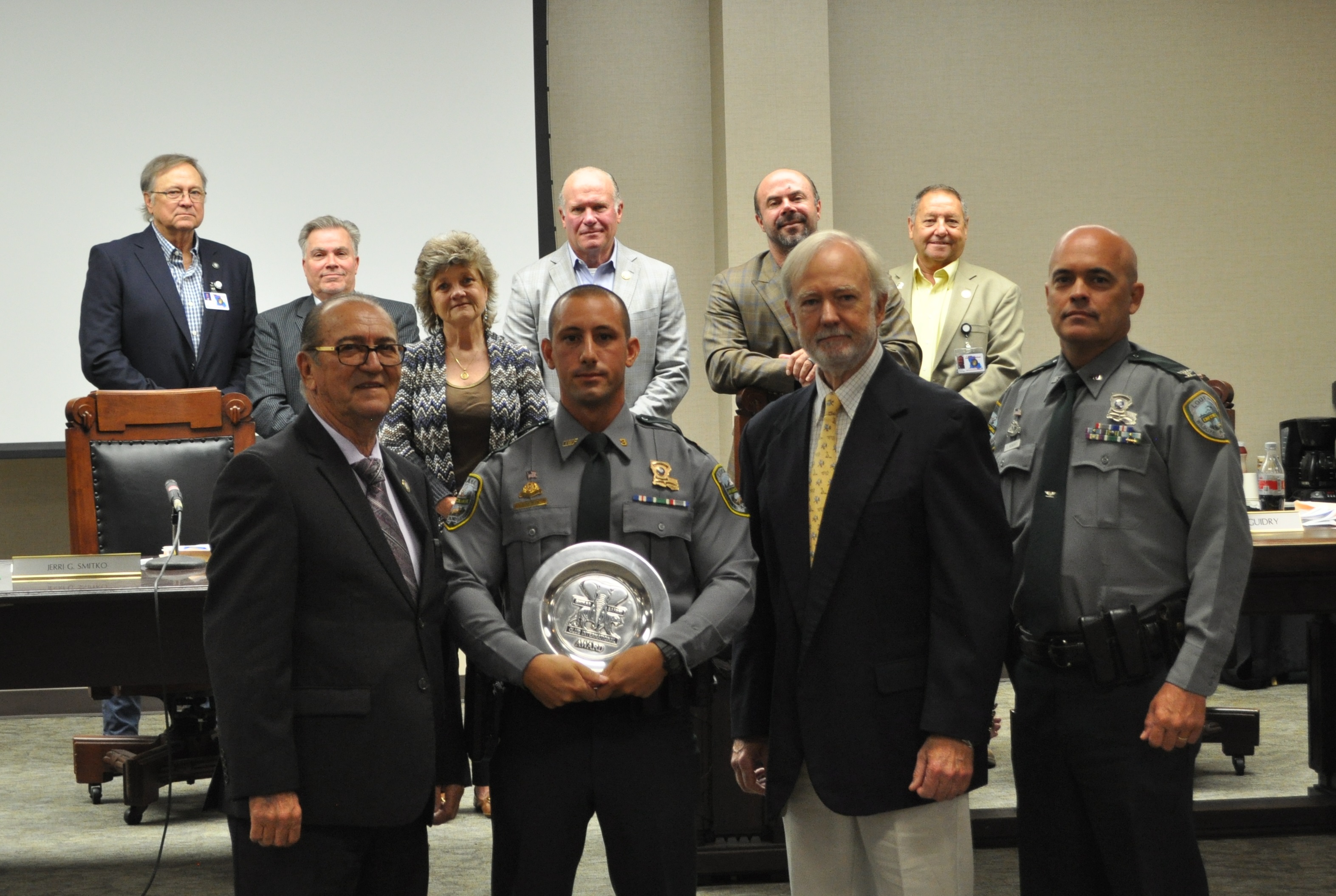 LDWF Sec. Jack Montoucet, Corporal Jame Bruce, Shikar-Safari Club Lea Perez, Col. Chad Hebert with the Louisiana Wildlife and Fisheries Commission members in the back.
