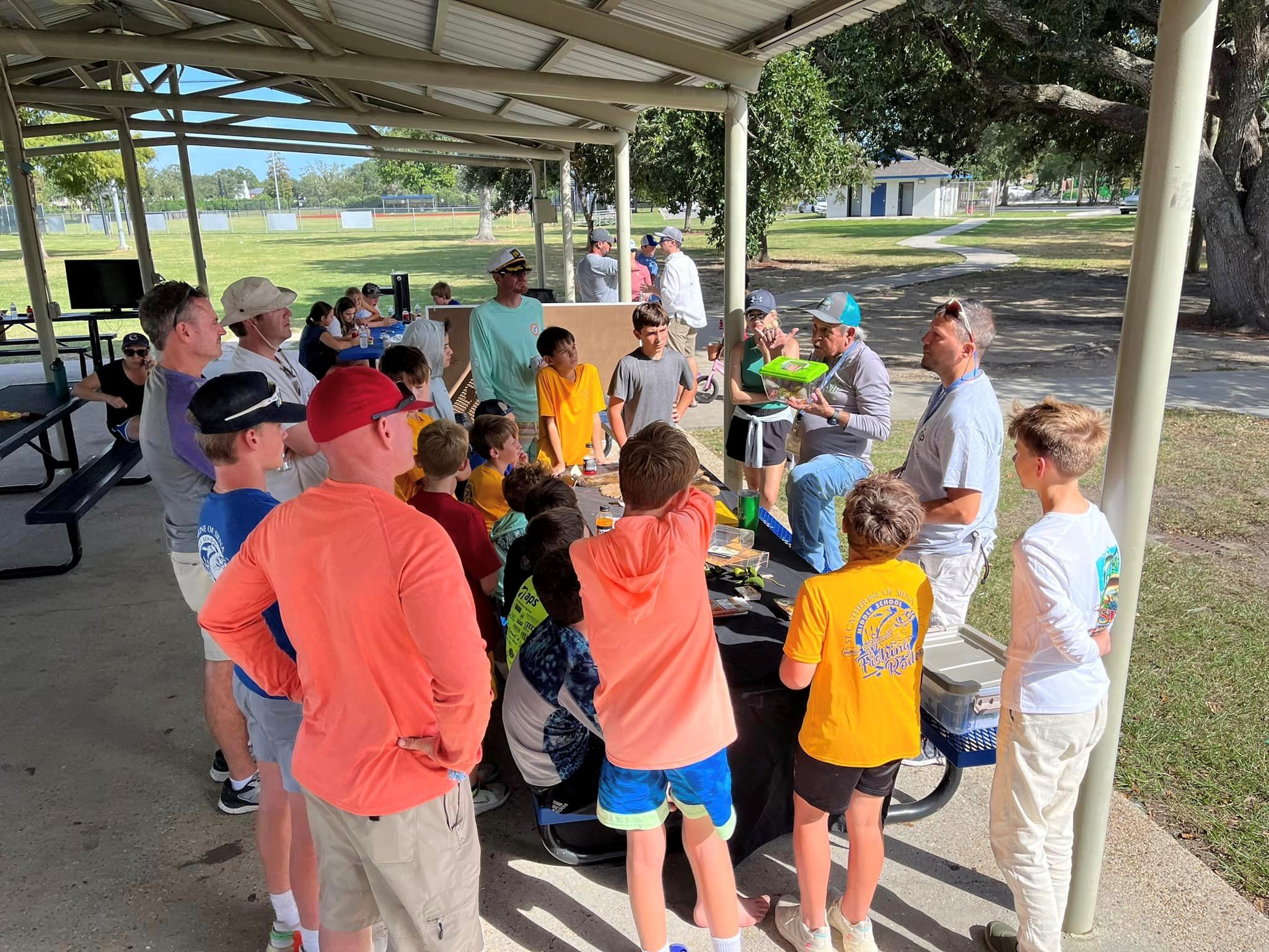 Aquatic Volunteer Instructors educate youth about aquatic invasive species at a fishing rodeo in Metairie, LA.