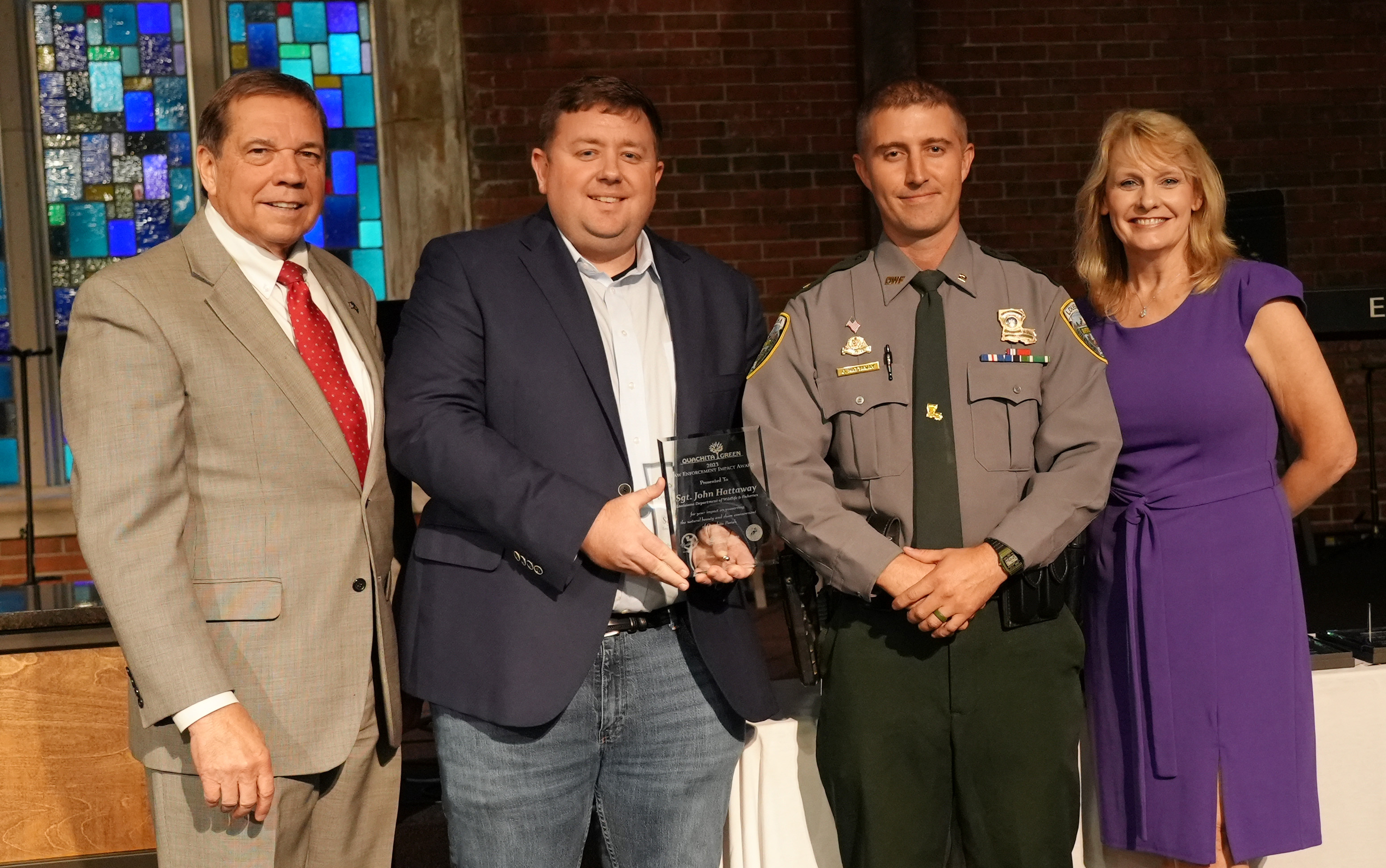 LDWF Secretary Rob Shadoin (from left), Ouachita Green Board Member Cameron Brister and Ouachita Green Executive Director Sheila Kay Downhour (far right) present the Law Enforcement Award to Sgt. John Hattaway at the Ouachita Green Awards Luncheon Thursday, Oct. 5, in the Biedenharn Family Life Center at First Methodist Church in Monroe.