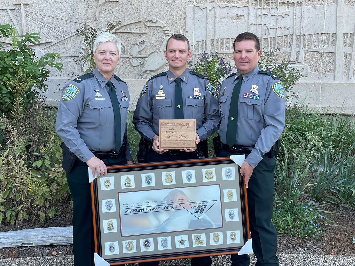 Col. Rachel Zechenelly, Corporal Joshua Harris and Major Rick Owens with award