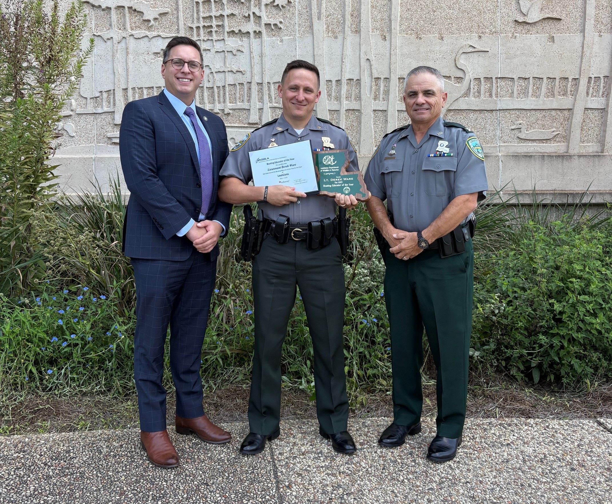 Lt. Derek Ware with award, secretary and colonel